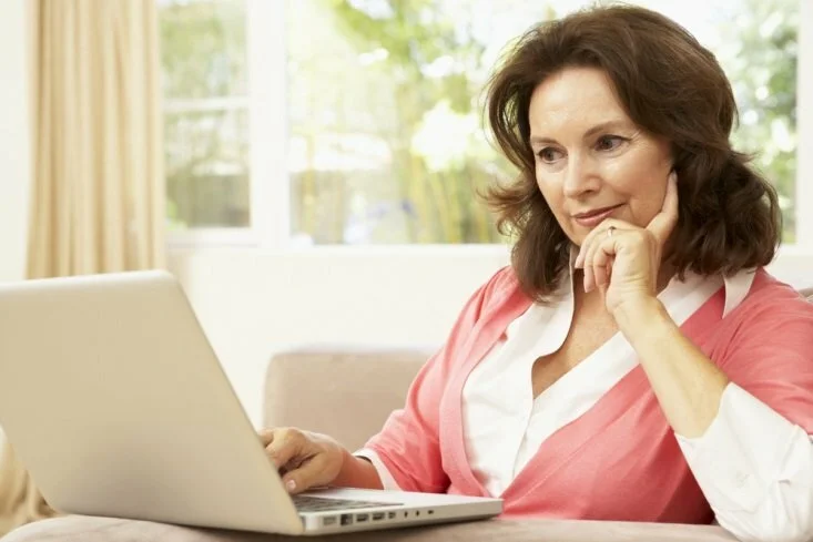 Menopause Woman with computer CanadianPharmacyMeds.com