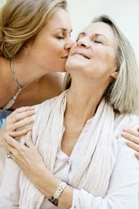 Woman kissing and embracing her mother CanadianPharmacyMeds.com