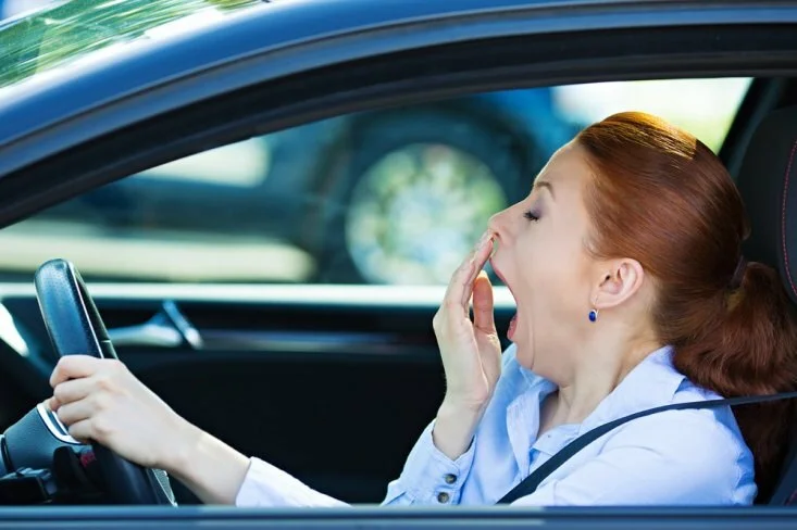 Woman sneezing while driving CanadianPharmacyMeds.com