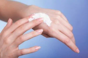 Woman taking proper care of her dry hand with lotion CanadianPharmacyMeds.com