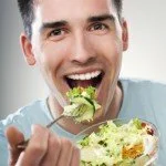 Man trying to be healthy by eating a salad CanadianPharmacyMeds.com