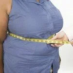 Obese woman with heartburn CanadianPharmacyMeds.com