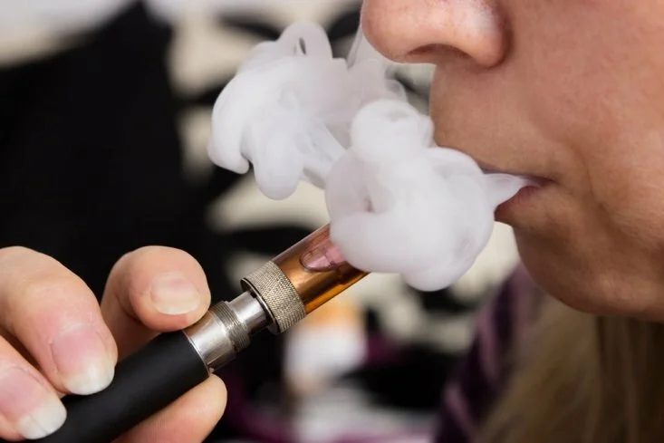 Woman vaping CanadianPharmacyMeds.com