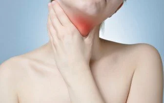 Young woman holding her painful neck